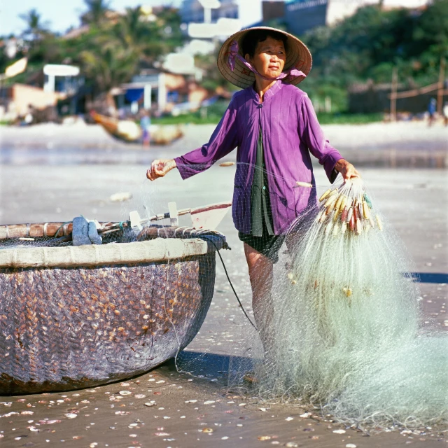 a woman wearing a purple top standing by a net