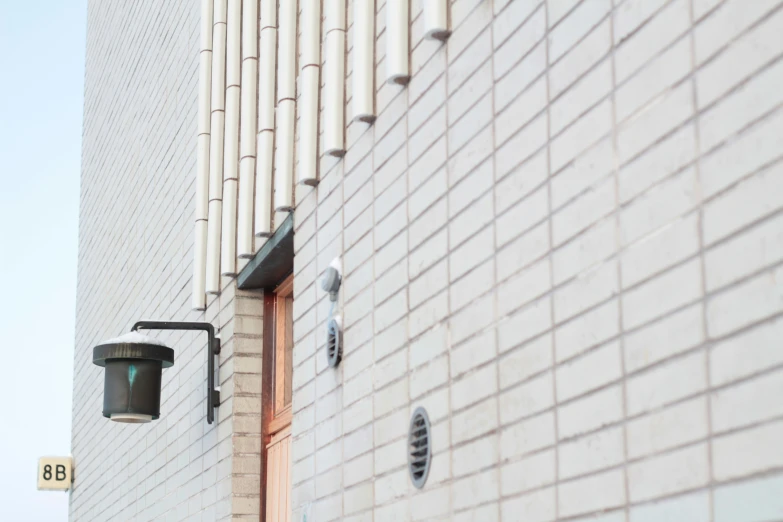 two different cameras are outside a building with the brick facade