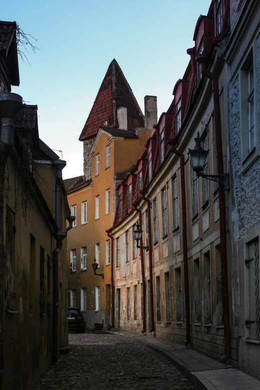 a narrow alley with cobblestone stones in old european town