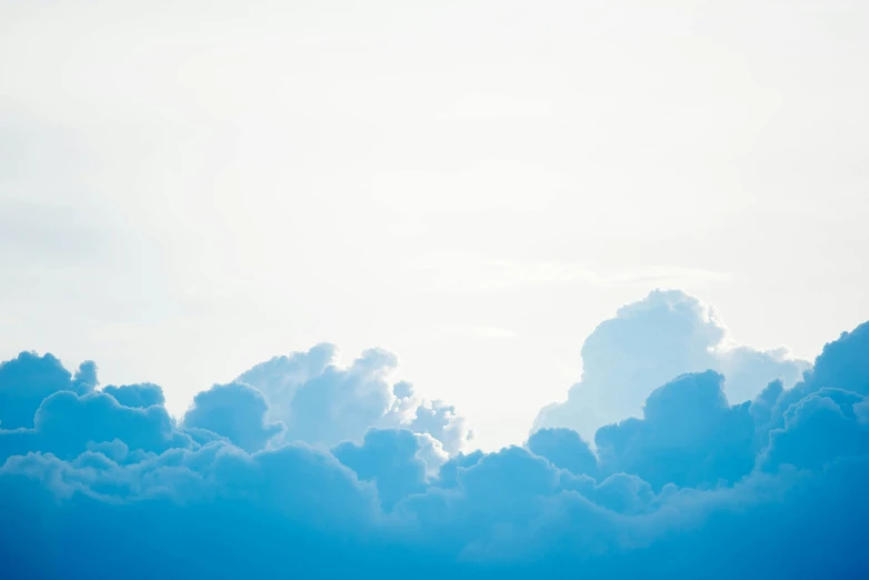 clouds in the sky, with a jet airliner in the foreground