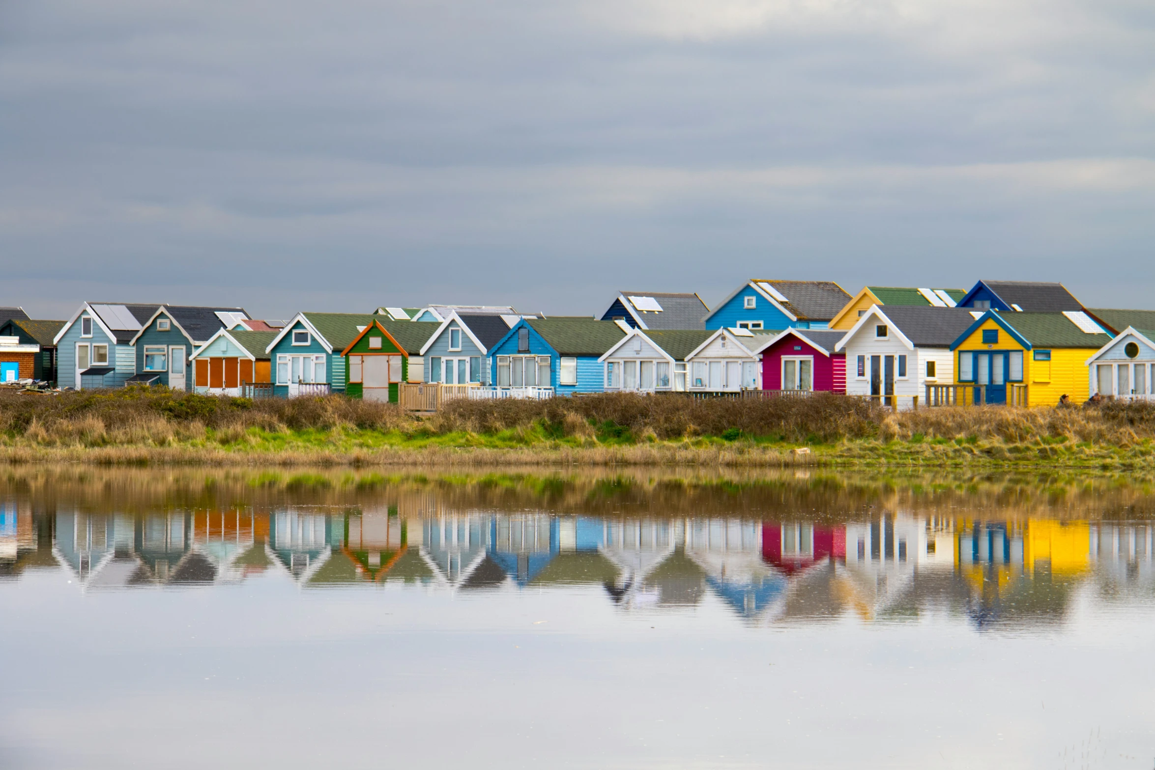 houses on a grassy island with reflections in the water