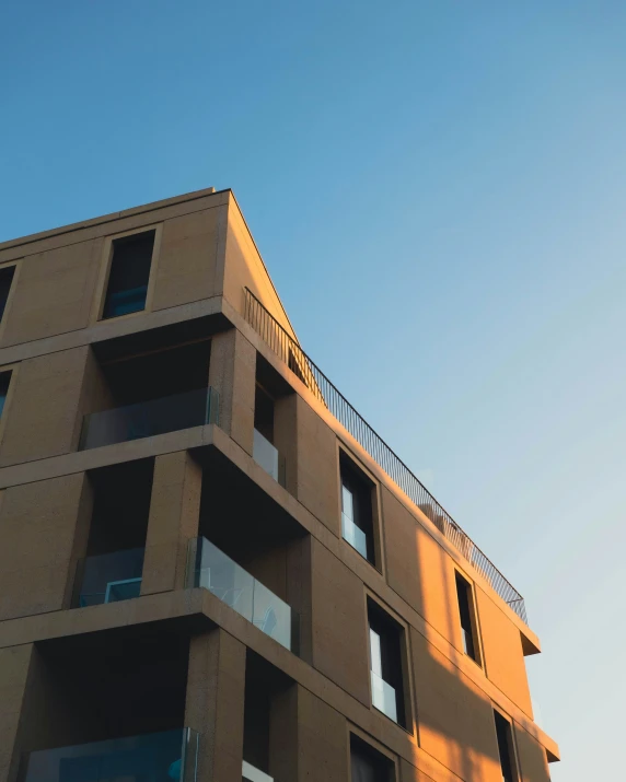 tall building with multiple balconies and metal railings