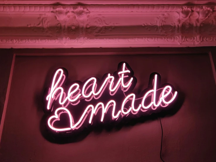 a neon sign that reads heartmade over the top