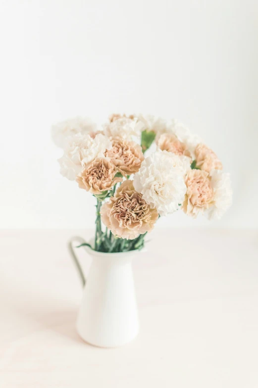 some white flowers in a white pitcher