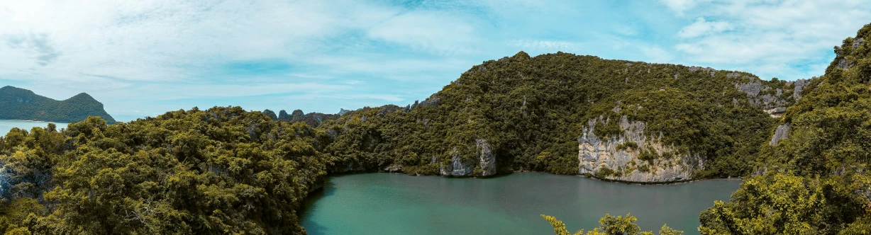 there is a blue lake surrounded by hills and trees