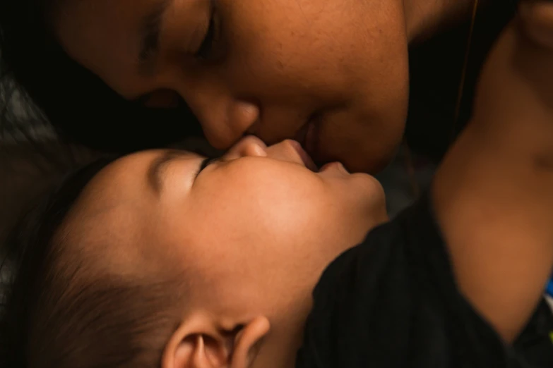 a woman and child are sleeping together