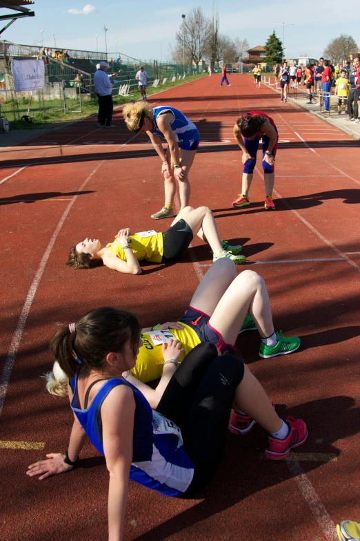 a group of people laying on a track