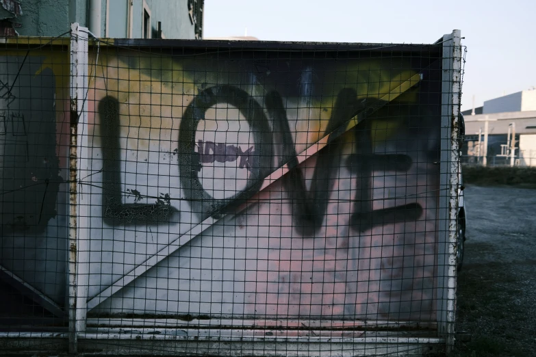 a graffittid box with tiles and letters painted on it