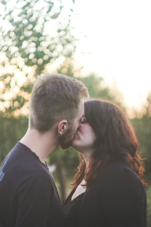 a man and woman kissing under the light