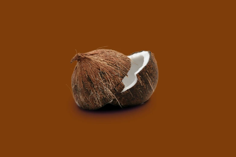 a coconut has been peeled and placed on an orange background