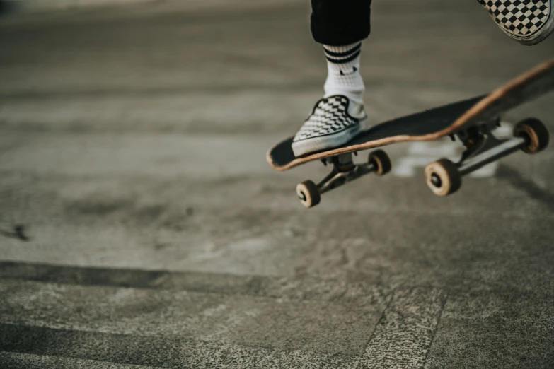 a person with black and white socks is on a skateboard