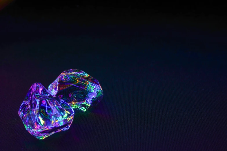 a brightly colored object sitting on top of a black surface