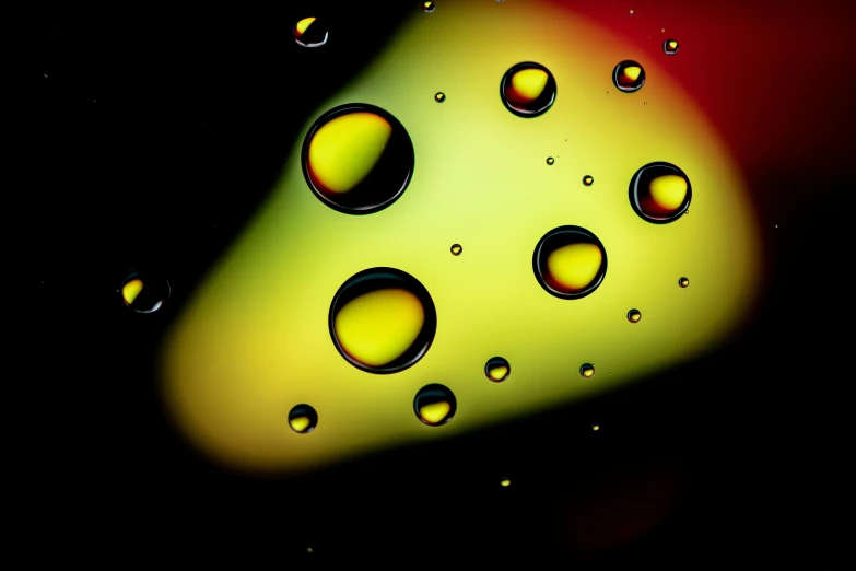a colorful picture with drops on a black background