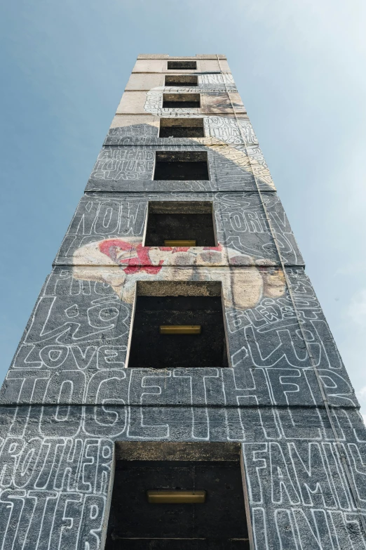 a tall building with graffiti written on it