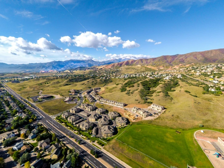 an aerial s of an open highway near a city