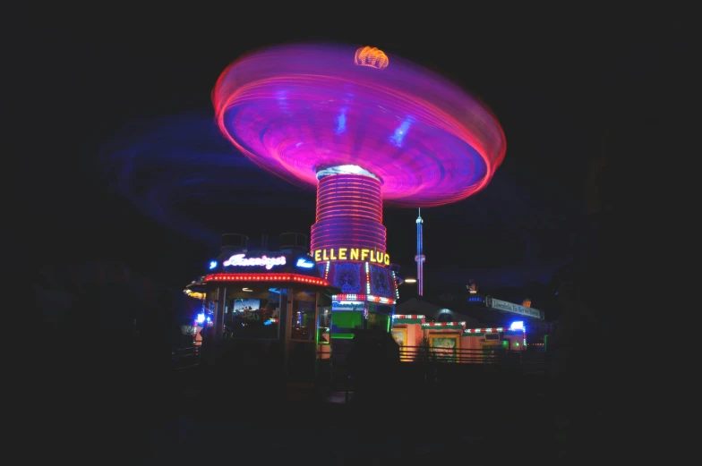 a carousel on a dark city street at night