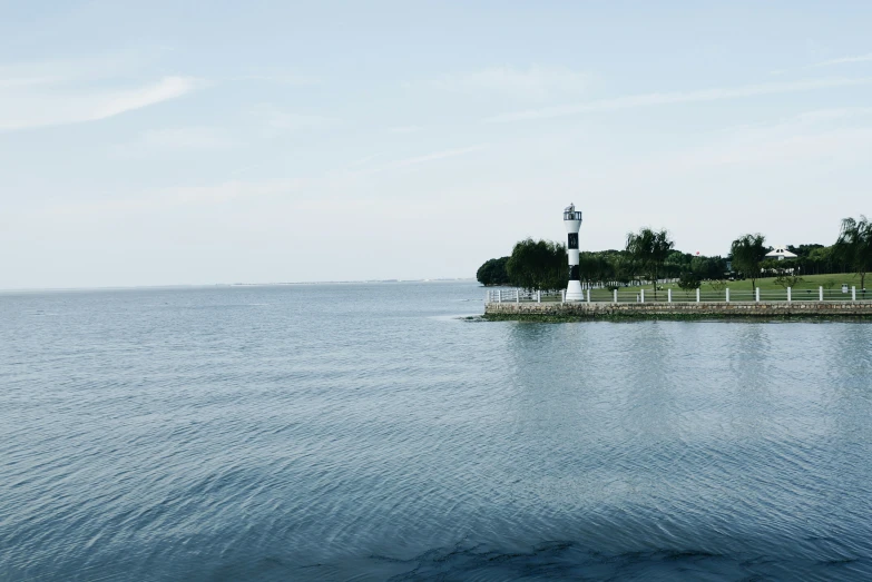 the view of a pier on the side of a lake