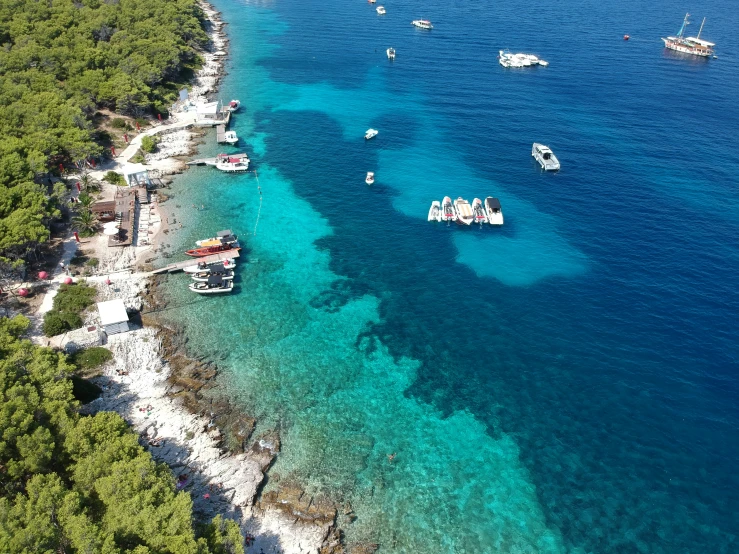 boats anchored in shallow waters off the coast of an island