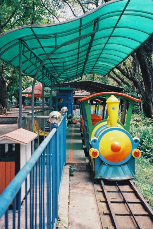a train rides on a track through the park
