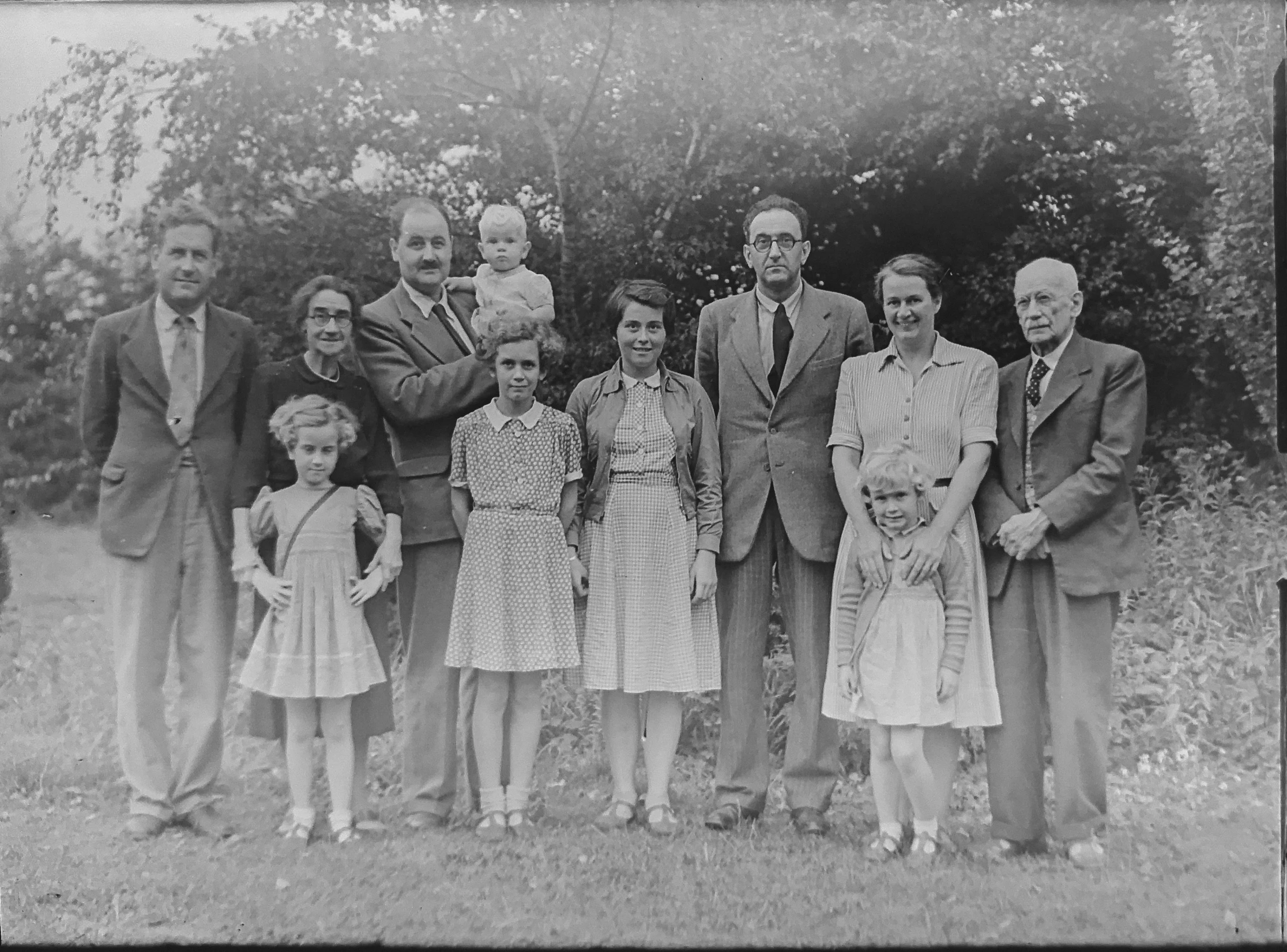 an old pograph of several people standing together