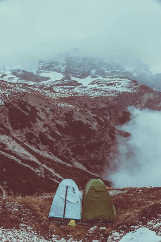 two camping tents pitched in a snowy mountain