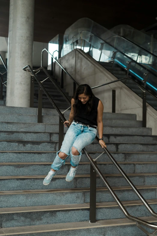 woman using cell phone while sitting on steps