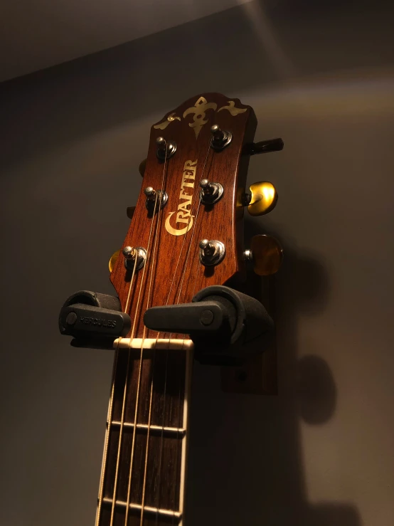 an acoustic guitar mounted on the wall