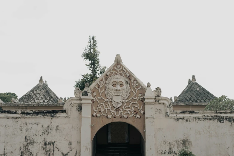 an archway that has a wall decoration over it