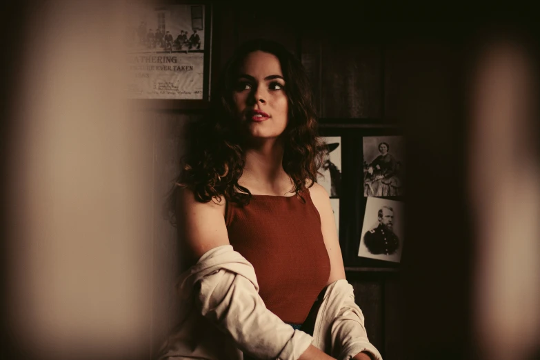 a woman sitting on top of a bed next to an arm cast