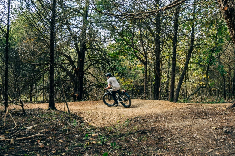 a cyclist is riding his bike through the woods