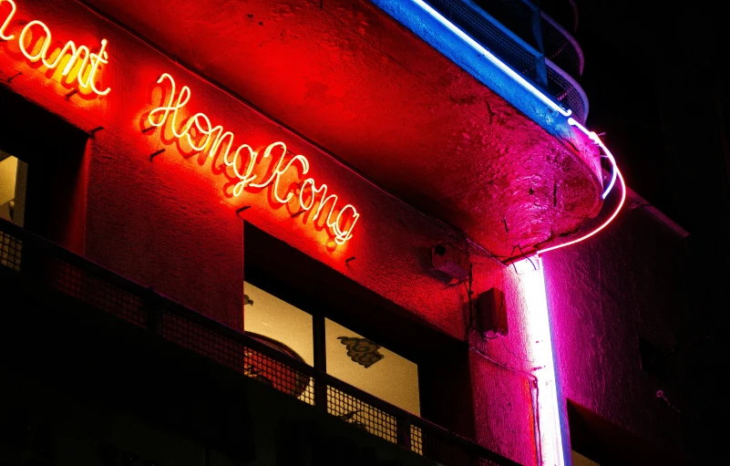 a neon sign for a restaurant on the side of a building