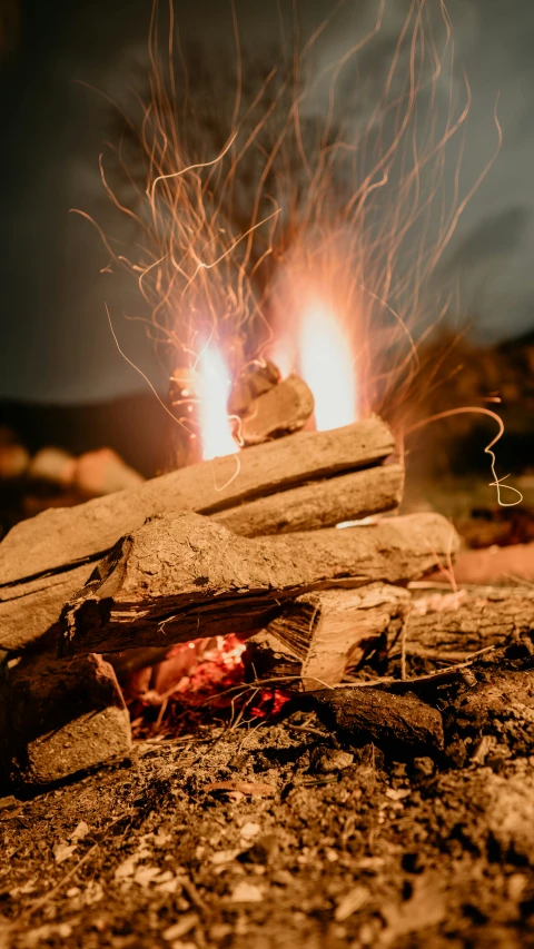 two  rocks sit on a pile with flames in the background