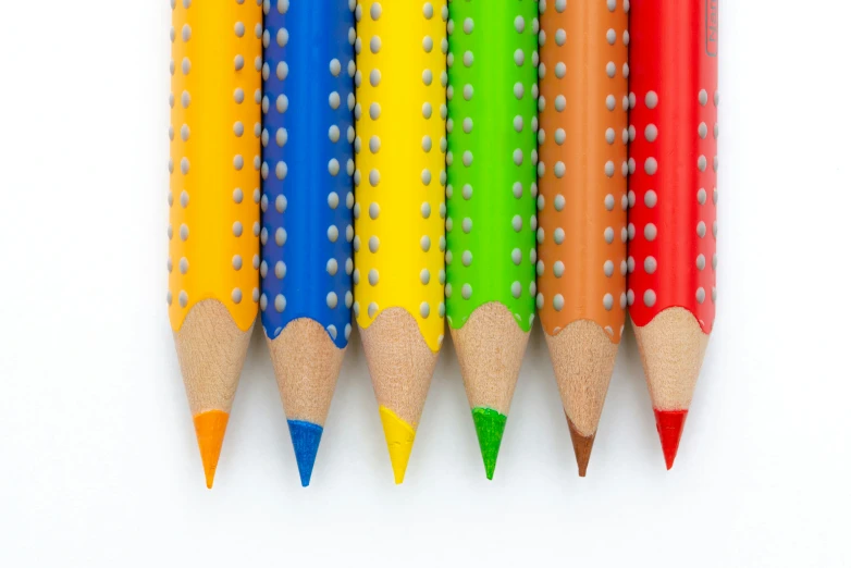 several colored pencils with different shapes and sizes