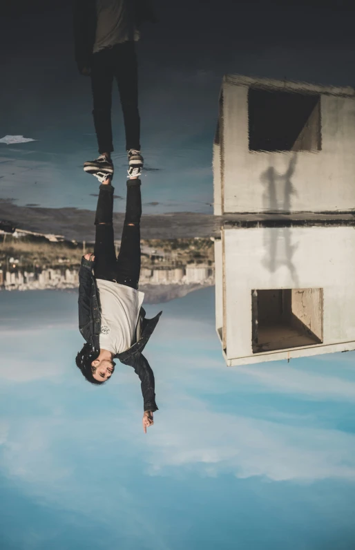 a man standing on his back and upside down