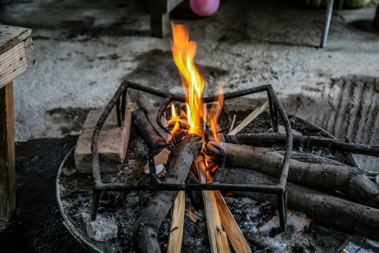 a small metal structure with some fire on it