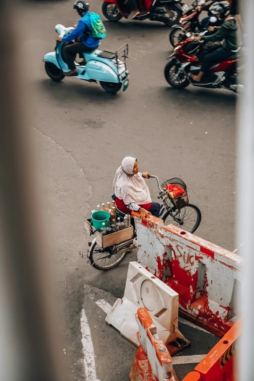 motorcycles and scooters are on the road, in the distance