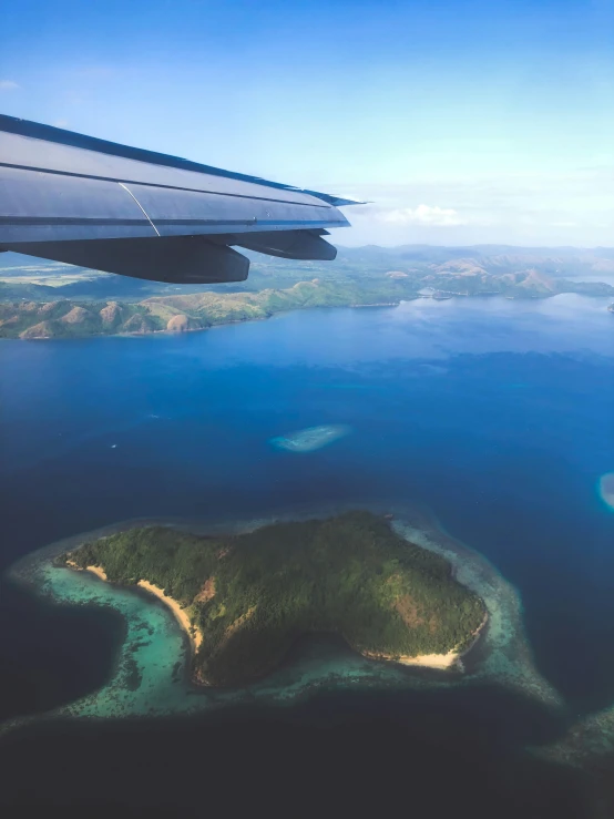 a view of an island in the ocean from the airplane