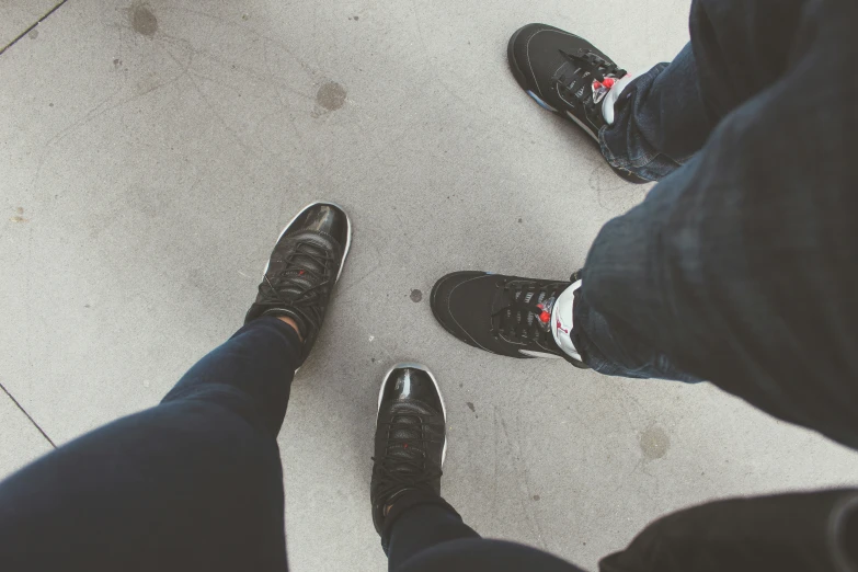 three people standing next to each other on a floor