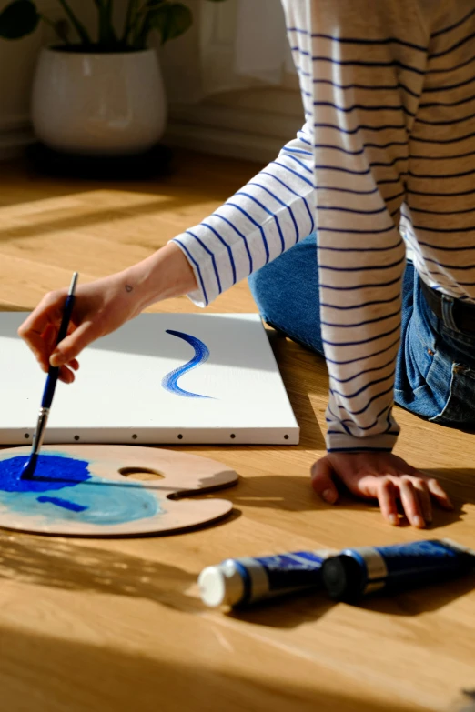 a  is painting his name on a piece of canvas