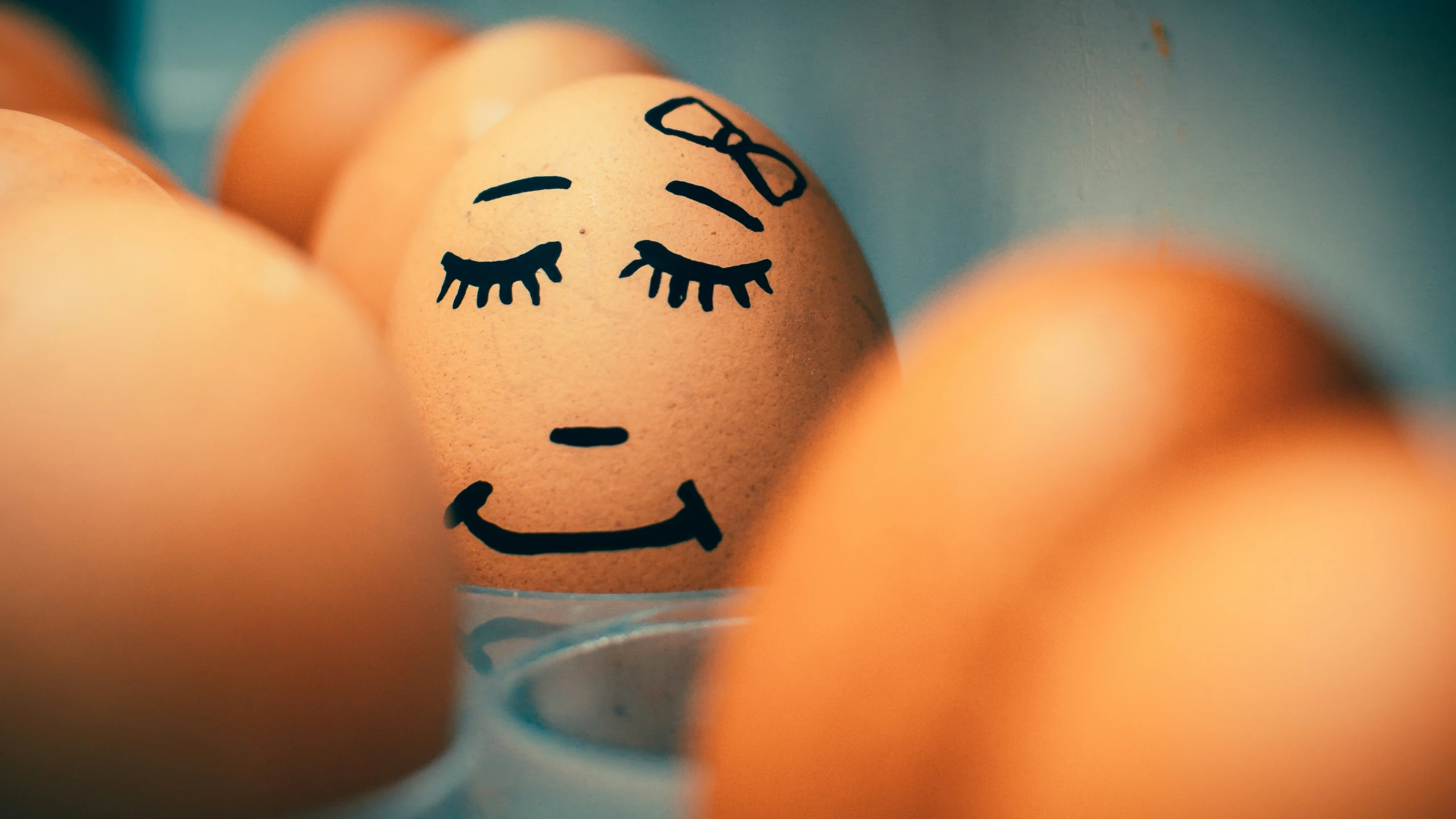 eggs in a glass are painted like faces