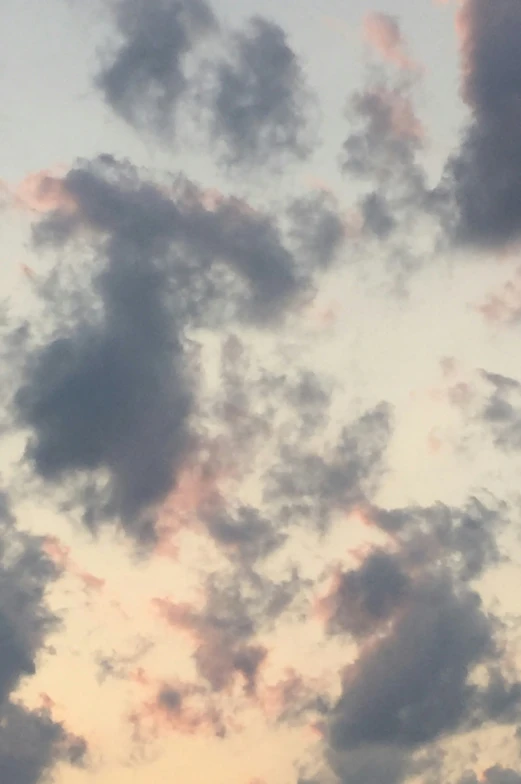 the silhouette of a plane flying through the sky at sunset