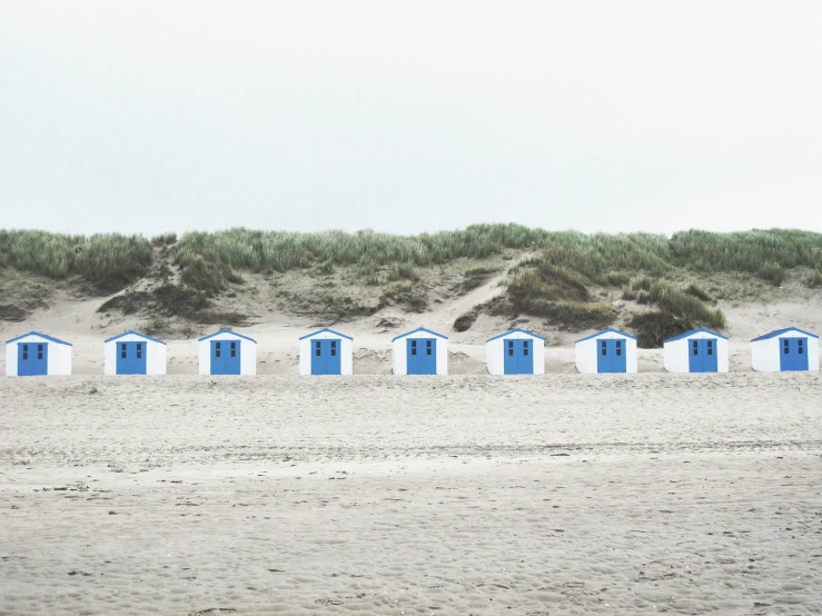 many beach huts have blue doors and windows