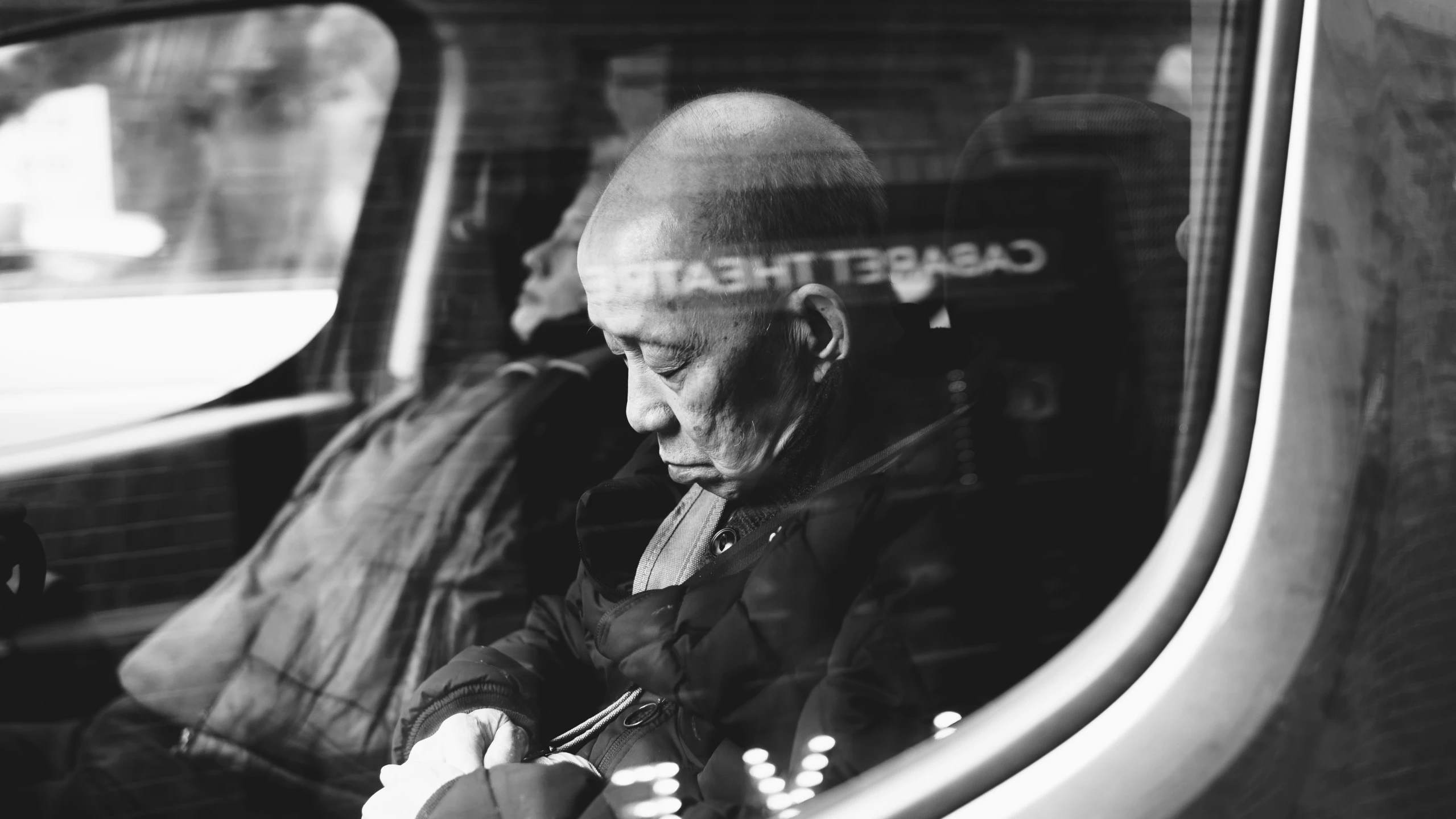 a man sitting next to his luggage inside a car