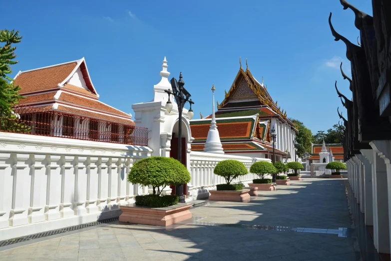 a courtyard that is lined with white and red roofs