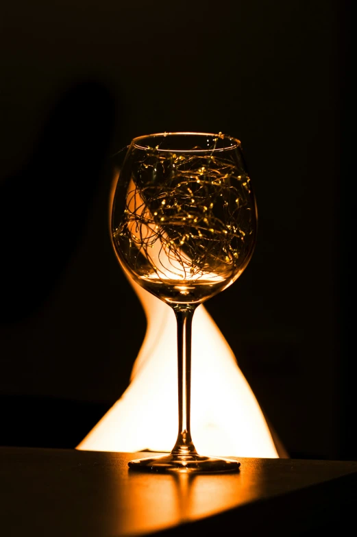 a glass with water in it on a table