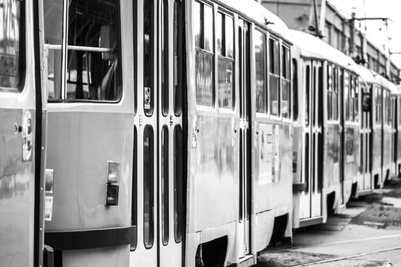 several city buses are parked side by side