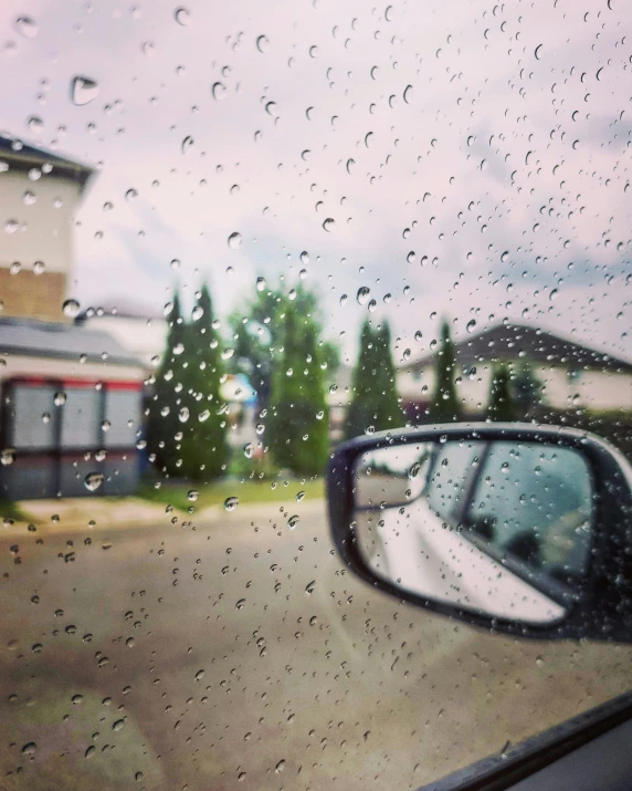 the rain is on the side view mirror of a car