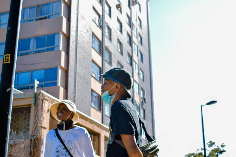 two people on their cell phones by the street