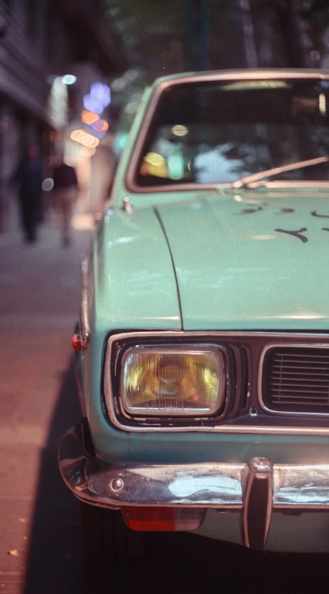 a mint green car parked on the side of the street