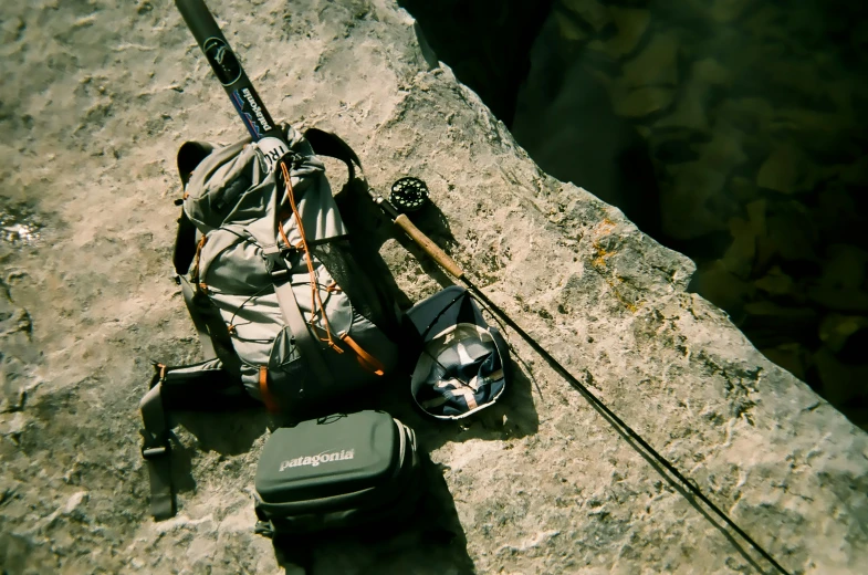 a rock climber carrying a camping kit and a backpack